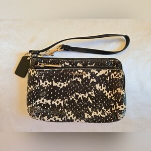 Coach Black and Cream Wristlet Clutch With Front Zip Pocket.